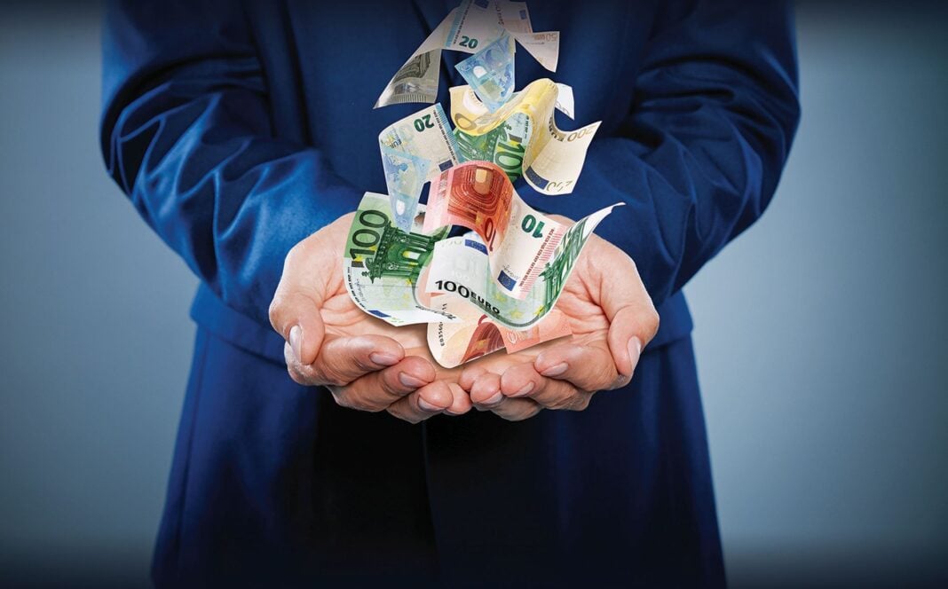 Businessman,With,Money,On,Dark,Background,,Closeup.,Currency,Exchange