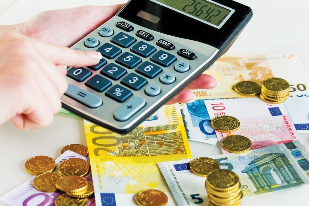 Hand,With,Calculator,And,Bills.,Symbolic,Photo,For,Turnover,,Profit,